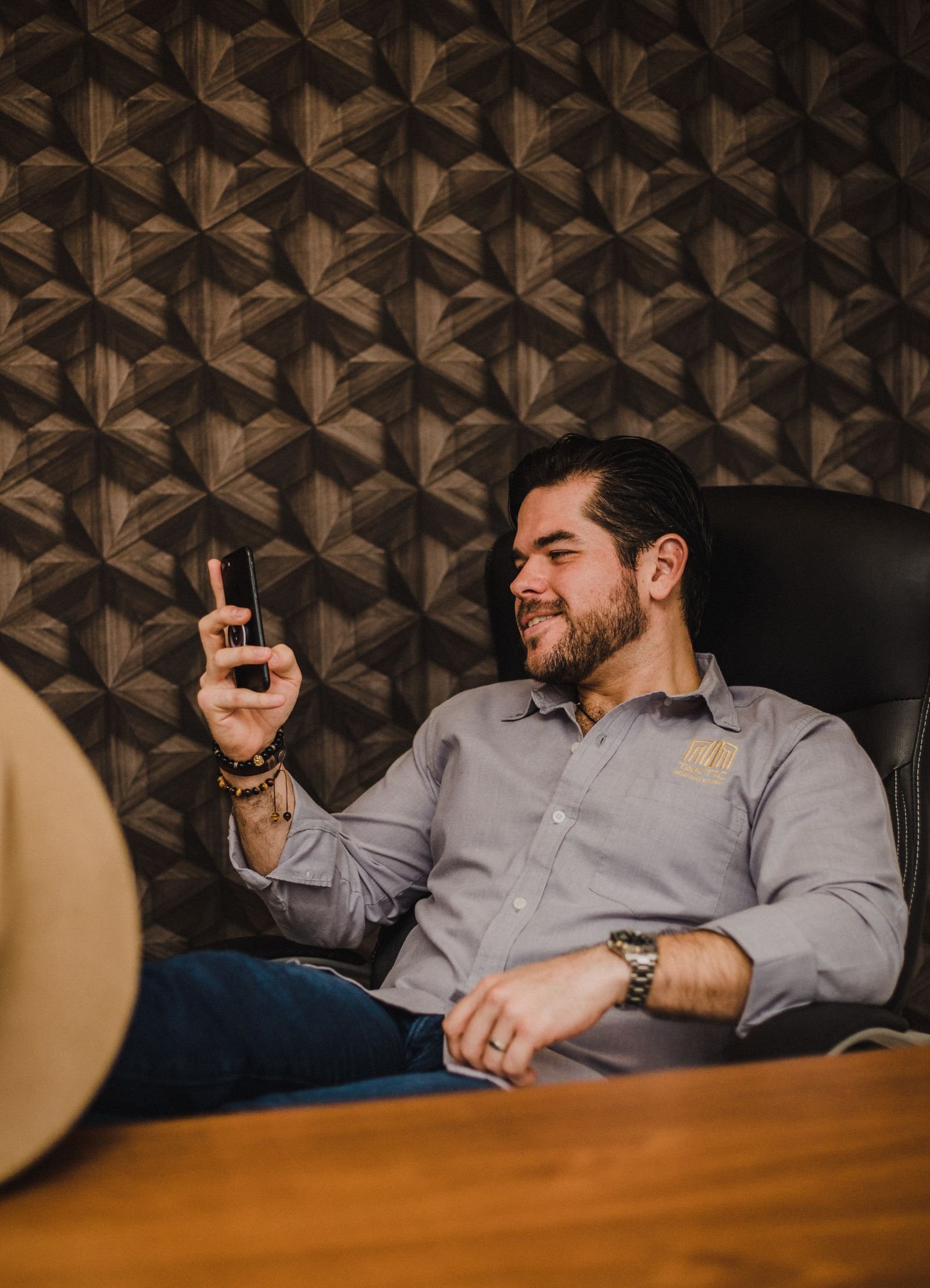 Smiling man using smartphone in office