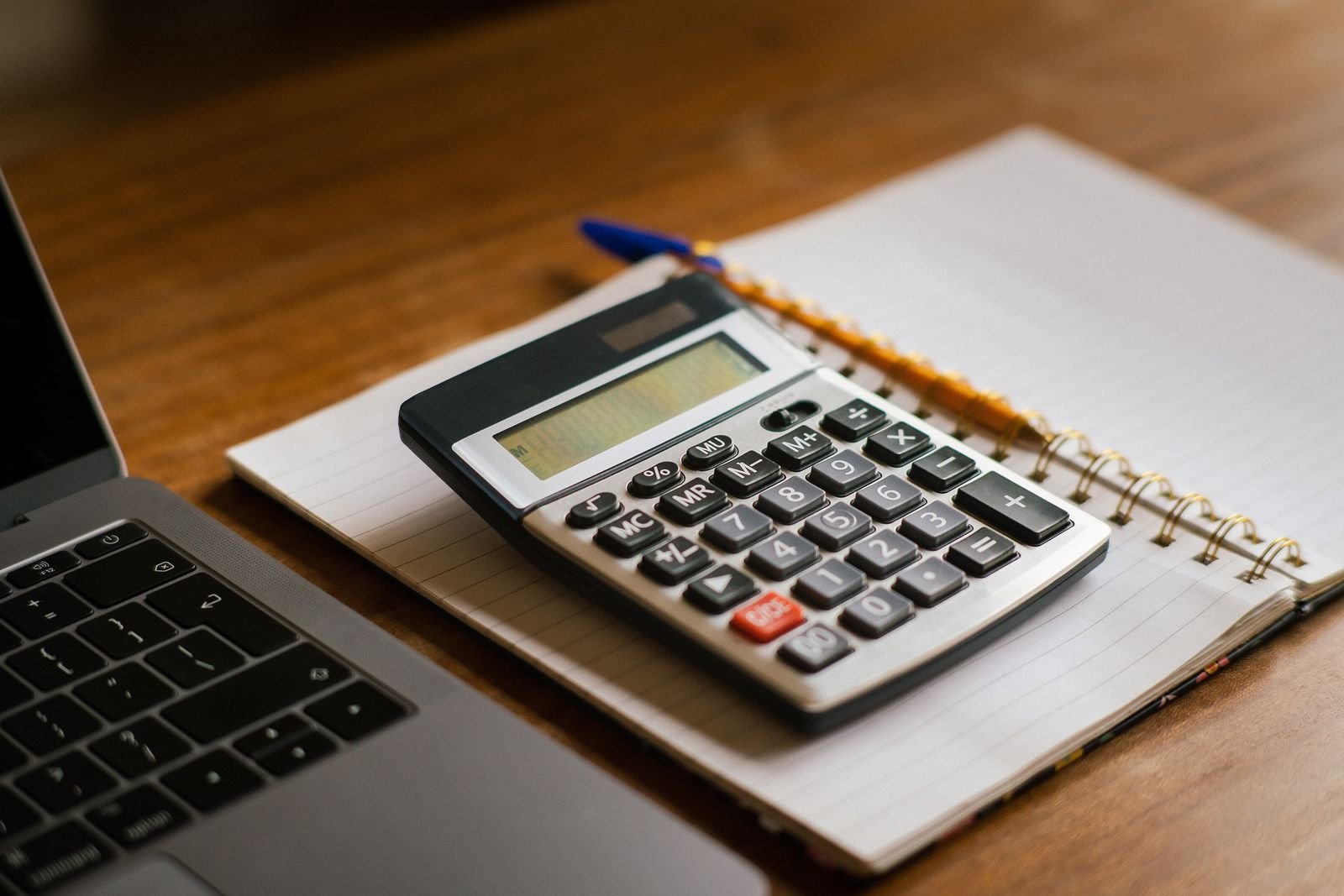 Accountant counting bills with a calculator