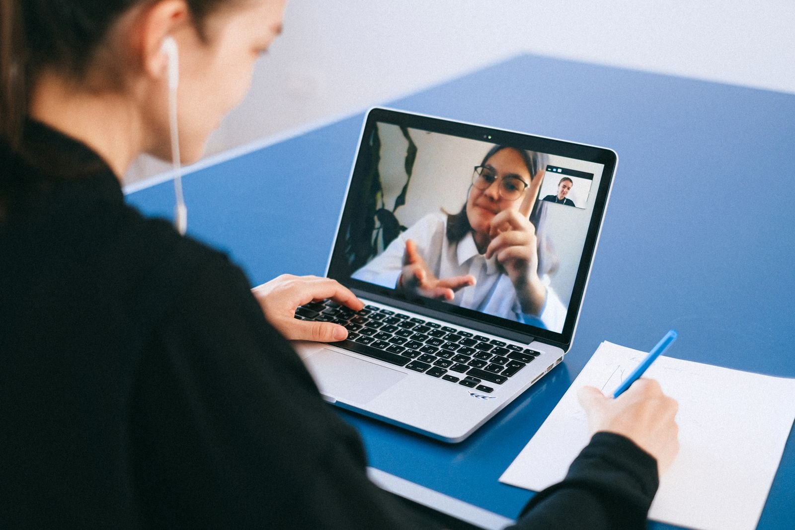 Person on a video call taking notes