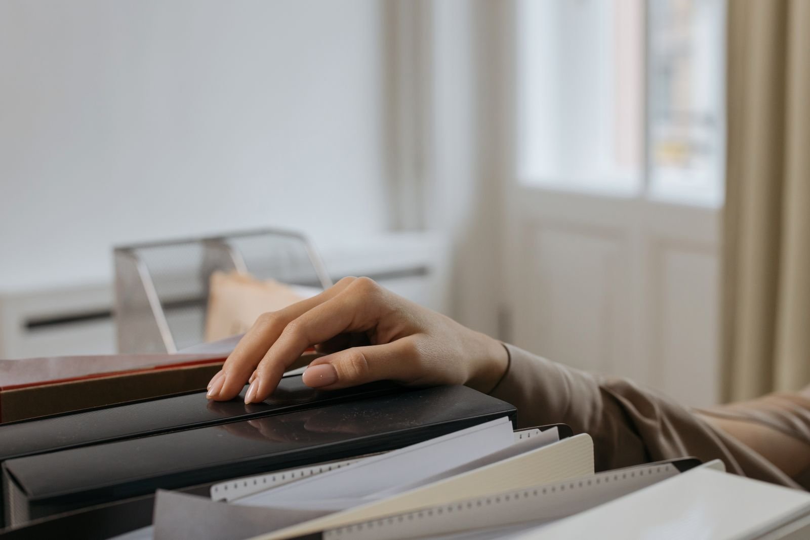 Person reaching for an office file folder