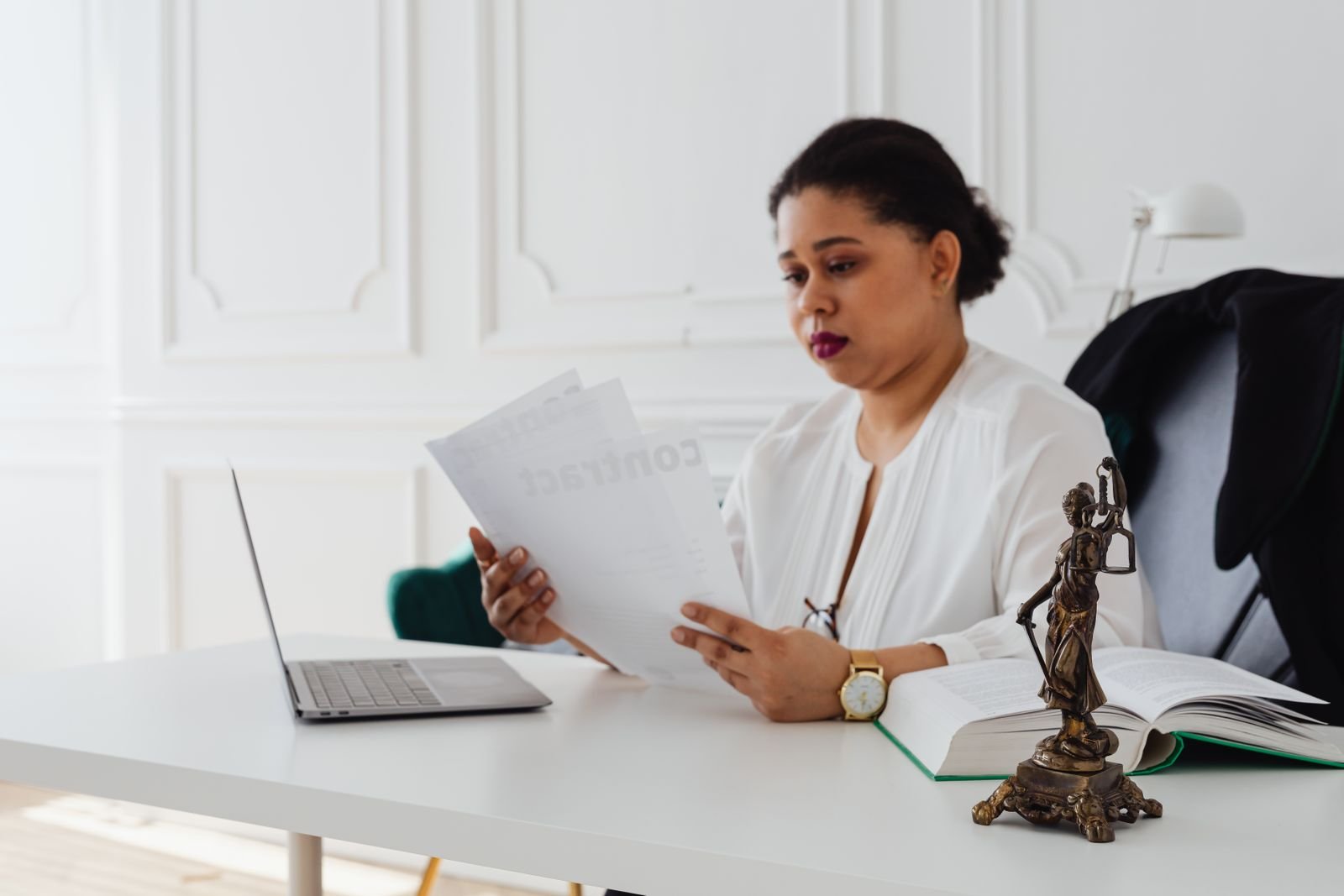 Woman reading documents at her desk
